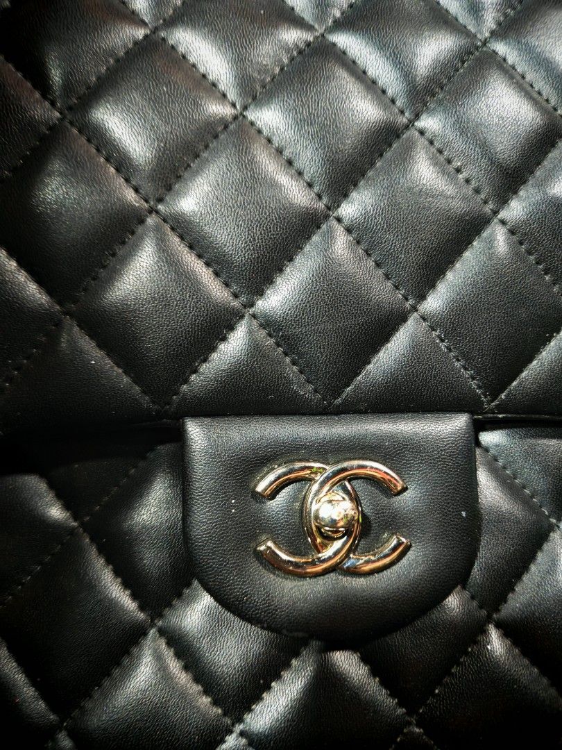 Black Quilted Leather Handbag with Chain Strap (Category: Luxury Bags & Wallets) located in Manila. Submitted by cleverwhale_45b7bc (Listing ID 1465105800, Image 2). Description: - Classic black quilted leather handbag - Silver-tone double chain strap - Iconic interlocking CC turn-lock front closure - Medium structured size - Grey interior lining with stitched CC logo on inner flap - Interior zipper pocket with EP zipper pull.
