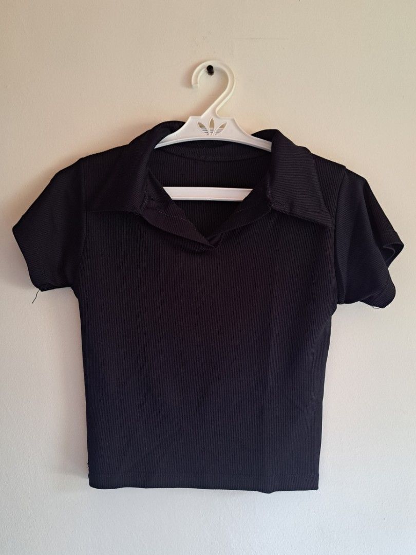 Black Ribbed Collar Crop Top Short Sleeve (Category: Shirts) located in Manila. Submitted by yselles__ (Listing ID 1464979251, Image 1). Description: - Color: Black - Material: Stretchable ribbed knit fabric - Design: Classic collared neckline with open V-neck and short sleeves - Fit: Body-hugging crop top, easy pullover style - Versatility: Perfect for pairing with high-waisted jeans, skirts, or shorts - Condition: Used twice.