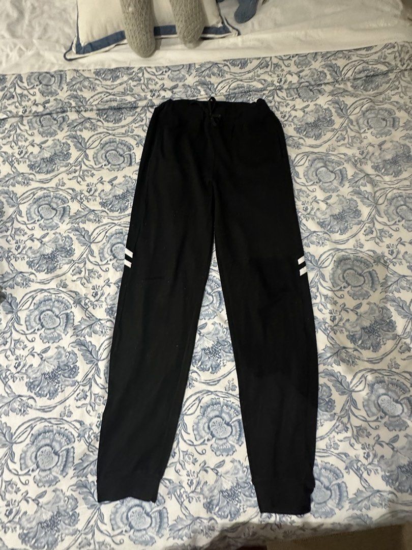 Black Sweatpants with white side stripes and drawstring waist (Category: Activewear) located in Manila. Submitted by cocoomelooonnnn (Listing ID 1465079259, Image 1). Description: - Color & Style: Black sweatpants featuring two white stripes on each leg - Waist & Fit: Elastic waistband with adjustable drawstring and secure ribbed ankle cuffs - Material: Soft cotton-blend fabric, perfect for workouts or casual lounging - Features: Standard side po