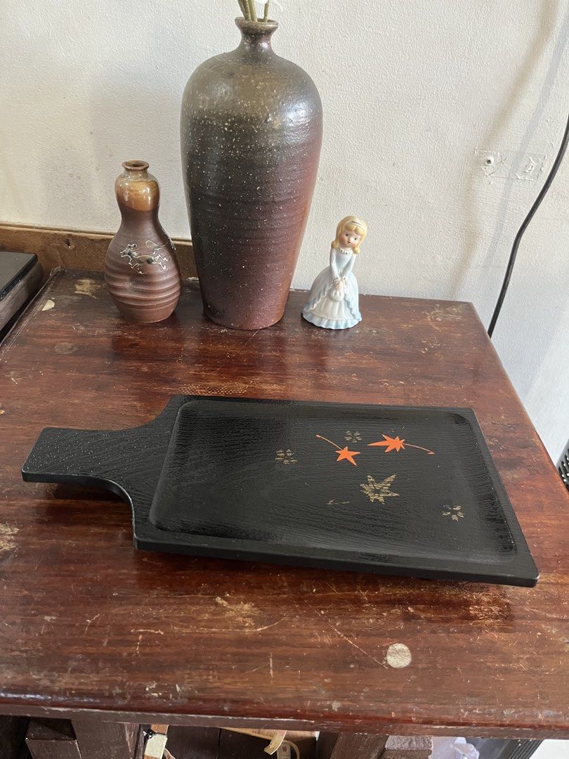 Black Wooden Serving Tray with Maple Leaf Motifs (Category: Dinnerware & Cutlery) located in Taguig. Submitted by minmin_parker (Listing ID 1465026682, Image 1). Description: - Material: Black wood with textured finish - Design: Painted orange and gold maple leaf details - Feature: Convenient paddle handle - Versatile: Perfect for serving drinks, organizing keys, or holding small items.