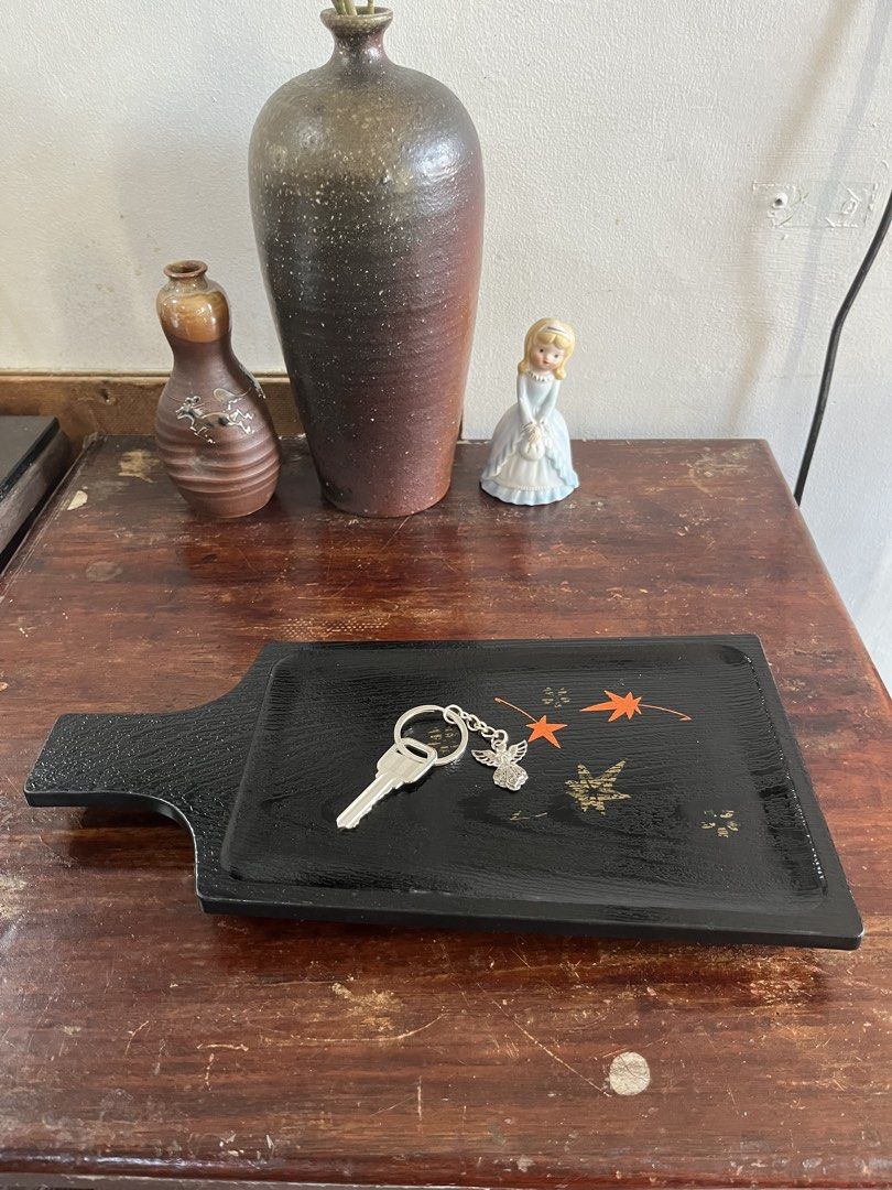 Black Wooden Serving Tray with Maple Leaf Motifs (Category: Dinnerware & Cutlery) located in Taguig. Submitted by minmin_parker (Listing ID 1465026682, Image 2). Description: - Material: Black wood with textured finish - Design: Painted orange and gold maple leaf details - Feature: Convenient paddle handle - Versatile: Perfect for serving drinks, organizing keys, or holding small items.