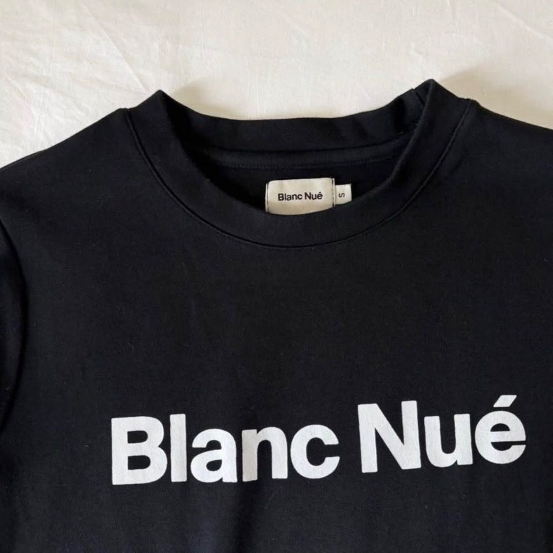 Blanc Nué Black Baby Tee (Category: Shirts) located in Paranaque City. Submitted by yanie.ae (Listing ID 1465070612, Image 2). Description: - Brand: Blanc Nué - Size: S - Color: Solid black with bold white chest logo - Style: Crew neck, short sleeves - Condition: Clean fabric, great for everyday casual outfits.