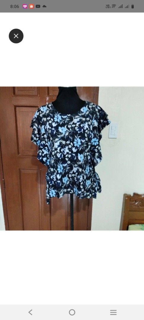 Blue and black floral print blouse (Category: Blouses) located in Tabaco. Submitted by kooki24 (Listing ID 1464969251, Image 1). Description: - Style: Short sleeve blouse with blue and black floral pattern - Fit: Loose, comfortable, and relaxed - Details: Trendy ruffled sleeves - Fabric: Lightweight and breathable - Pairing: Great with jeans or simple pants for casual days.