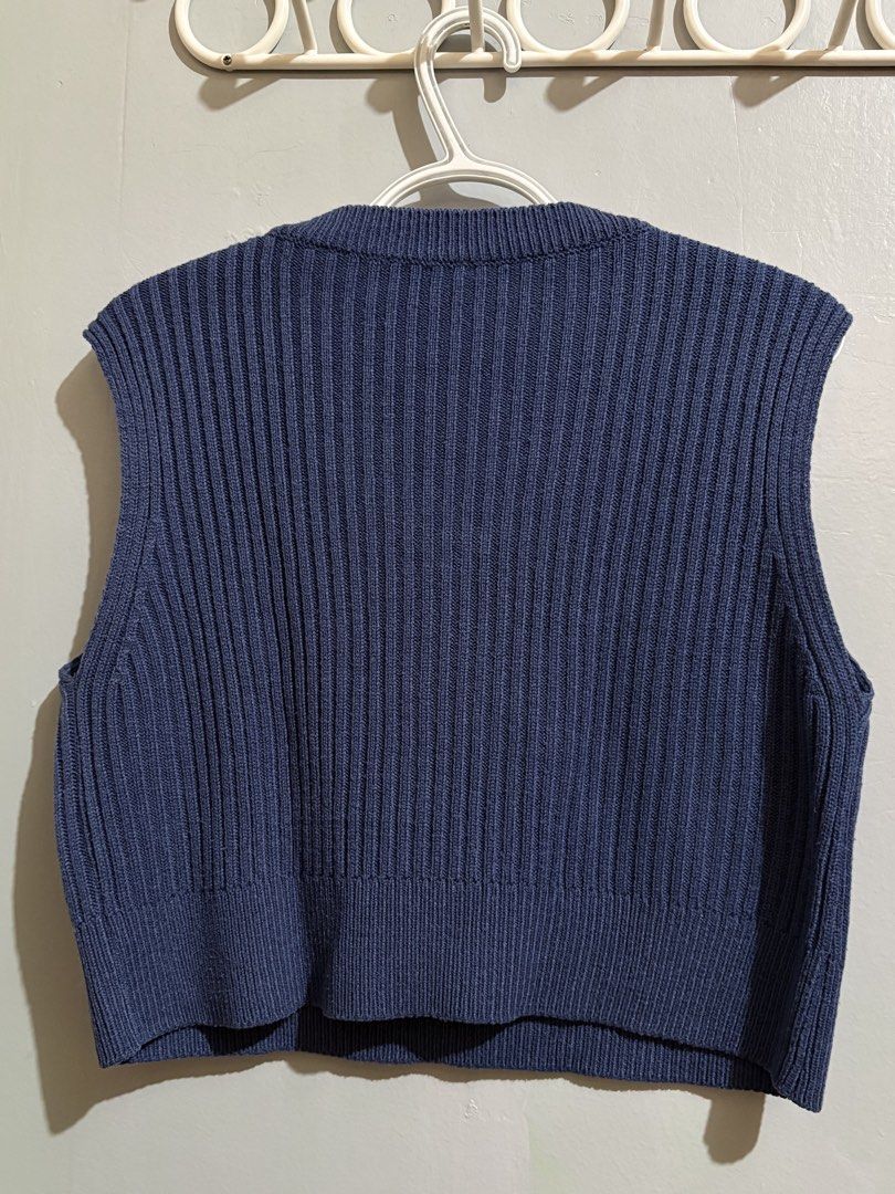 Blue Knit V-Neck Sweater Vest (Category: Sleeveless) located in Manila. Submitted by margascloset_ (Listing ID 1465053564, Image 2). Description: - Color: Dark Blue | Size: Fits Medium to Large - Style: Cropped V-neck knit sweater vest - Texture: Ribbed throughout body and hems - Fit: Sleeveless and cropped, great for layering; pre-loved RFS: Decluttering MOD: J&t, LBC, Lalamove, Grab MOP: Gcash / Bank.