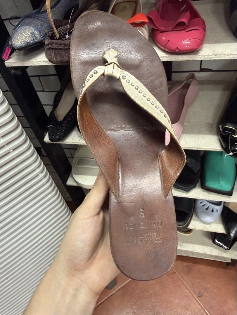 Bohemian Brown Wedge Sandals Size 6 (Category: Wedges) located in Manila. Submitted by fastlion.584bdf (Listing ID 1465062581, Image 2). Description: Bohemian wedge sandals in brown leather. Size 6 marked on the insole. White thong strap decorated with small rhinestones down the center. Wedge heel height gives a nice lift. Black rubber sole underneath with some wear from previous use. Made in Thailand. All leather construction..