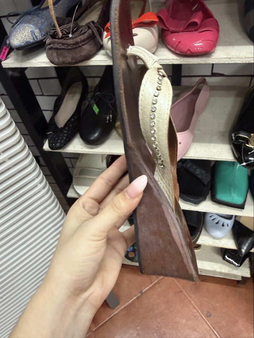 Bohemian Brown Wedge Sandals Size 6 (Category: Wedges) located in Manila. Submitted by fastlion.584bdf (Listing ID 1465062581, Image 3). Description: Bohemian wedge sandals in brown leather. Size 6 marked on the insole. White thong strap decorated with small rhinestones down the center. Wedge heel height gives a nice lift. Black rubber sole underneath with some wear from previous use. Made in Thailand. All leather construction..
