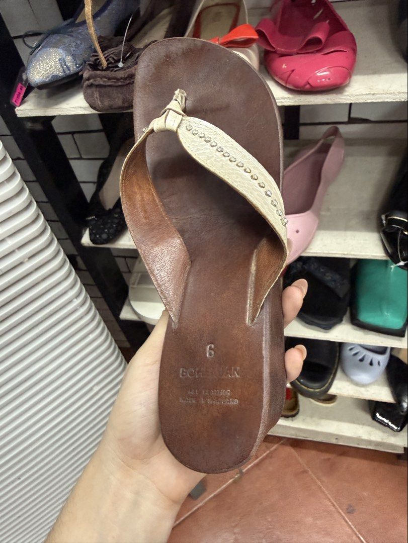 Bohemian Brown Wedge Sandals Size 6 (Category: Wedges) located in Manila. Submitted by fastlion.584bdf (Listing ID 1465062581, Image 1). Description: Bohemian wedge sandals in brown leather. Size 6 marked on the insole. White thong strap decorated with small rhinestones down the center. Wedge heel height gives a nice lift. Black rubber sole underneath with some wear from previous use. Made in Thailand. All leather construction..
