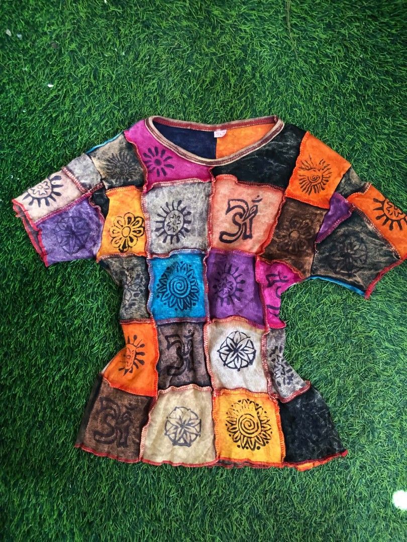 Boho Patchwork T-Shirt Multi-color Sun Print (Category: Shirts) located in Manila. Submitted by grandwater.53a8ce (Listing ID 1464988791, Image 1). Description: - Multi-color patchwork design with bright and earthy tones - Features unique sun, flower, and Om graphic prints - Comfortable round neckline with trendy exposed stitching - Soft and breathable fabric for everyday wear - Perfect casual bohemian style.