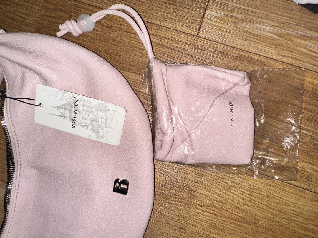 Bostanten Pink Crescent Hobo Bag with Mini Pouch (Category: Shoulder Bags) located in Manila. Submitted by edgiedge (Listing ID 1465032174, Image 2). Description: Bostanten pink crescent hobo bag. Still has the original tag attached. Includes a matching mini drawstring pouch in a separate plastic wrap. Soft textured finish, silver hardware, and a single shoulder strap. Zip closure across the top with fabric-lined interior and zipper pocket inside