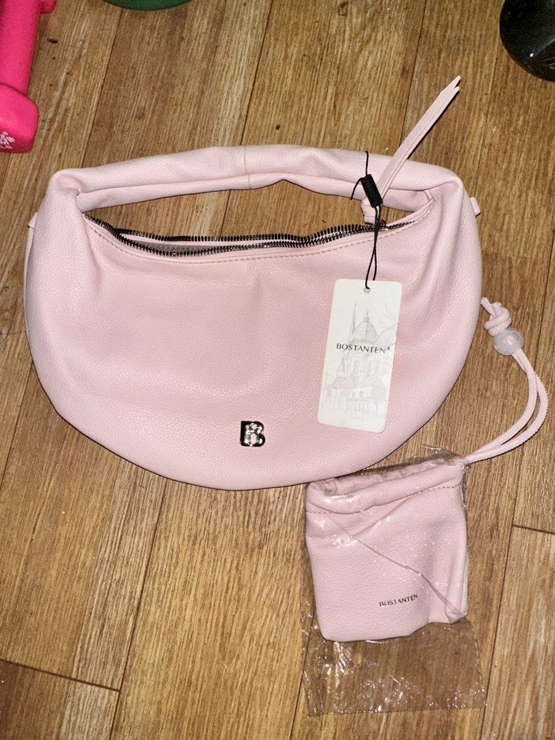 Bostanten Pink Crescent Hobo Bag with Mini Pouch (Category: Shoulder Bags) located in Manila. Submitted by edgiedge (Listing ID 1465032174, Image 1). Description: Bostanten pink crescent hobo bag. Still has the original tag attached. Includes a matching mini drawstring pouch in a separate plastic wrap. Soft textured finish, silver hardware, and a single shoulder strap. Zip closure across the top with fabric-lined interior and zipper pocket inside