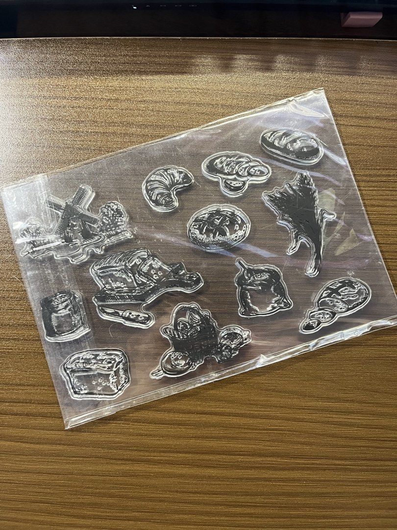 Bread Clear Stamp Sheet (Category: Craft Supplies & Tools) located in Manila. Submitted by theinkwaddle (Listing ID 1465011755, Image 1). Description: - Product: Clear silicone bread stamp sheet - Designs: Croissants, sliced bread, windmill, flour sack, and wheat stalks - Features: Transparent material for easy alignment with acrylic blocks - Perfect for: Journaling, scrapbooking, card making, and paper crafts - Meetup/Shipping available.