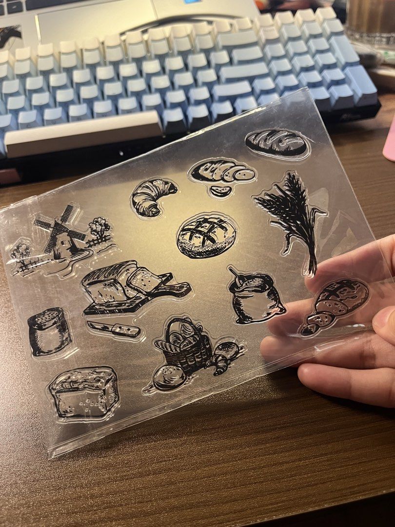 Bread Clear Stamp Sheet (Category: Craft Supplies & Tools) located in Manila. Submitted by theinkwaddle (Listing ID 1465011755, Image 2). Description: - Product: Clear silicone bread stamp sheet - Designs: Croissants, sliced bread, windmill, flour sack, and wheat stalks - Features: Transparent material for easy alignment with acrylic blocks - Perfect for: Journaling, scrapbooking, card making, and paper crafts - Meetup/Shipping available.