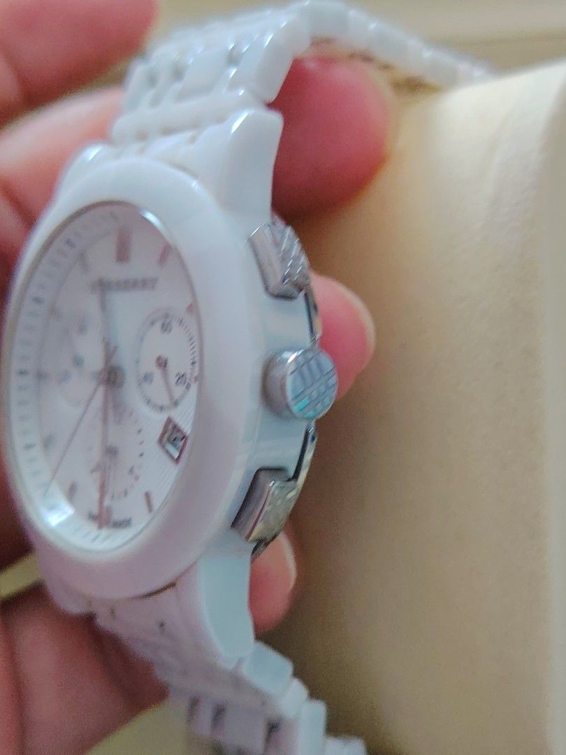 Burberry Ceramic Chronograph White Watch (Category: Luxury Watches) located in Paranaque City. Submitted by lucille1280 (Listing ID 1464991813, Image 3). Description: - Brand: Burberry - Type: Chronograph watch with Swiss-made movement - Color/Material: Premium white ceramic case and link bracelet - Dial: Textured white dial with date window (between 4 and 5 o'clock) and 3 sub-dials - Closure: Secure deployment clasp - Details: Water-resistant wi