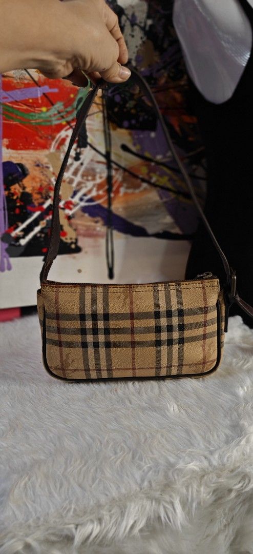 Burberry Check Nova Shoulder Bag (Category: Luxury Bags & Wallets) located in Las Pinas. Submitted by liezel49 (Listing ID 1465016482, Image 1). Description: Classic Burberry check shoulder bag in beige canvas with brown leather trim. Features a top zip closure, gold-tone hardware, and a clean interior. Shows minor wear on leather edges. Perfect compact size for daily use..