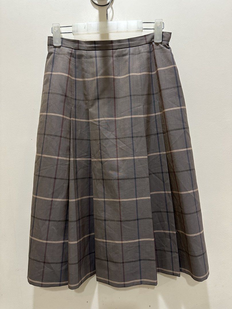 BURBERRY SKIRT (Category: Luxury Apparel) located in Iloilo. Submitted by toppingsboutique2.0 (Listing ID 1465001105, Image 1). Description: BURBERRY SKIRT • Pattern: Brown and grey-toned plaid/check with thin accent lines. • Style: Mid-length pleated skirt with structured box pleats. • Material: Typically crafted from wool with a cupra or synthetic lining in vintage Burberry collections..