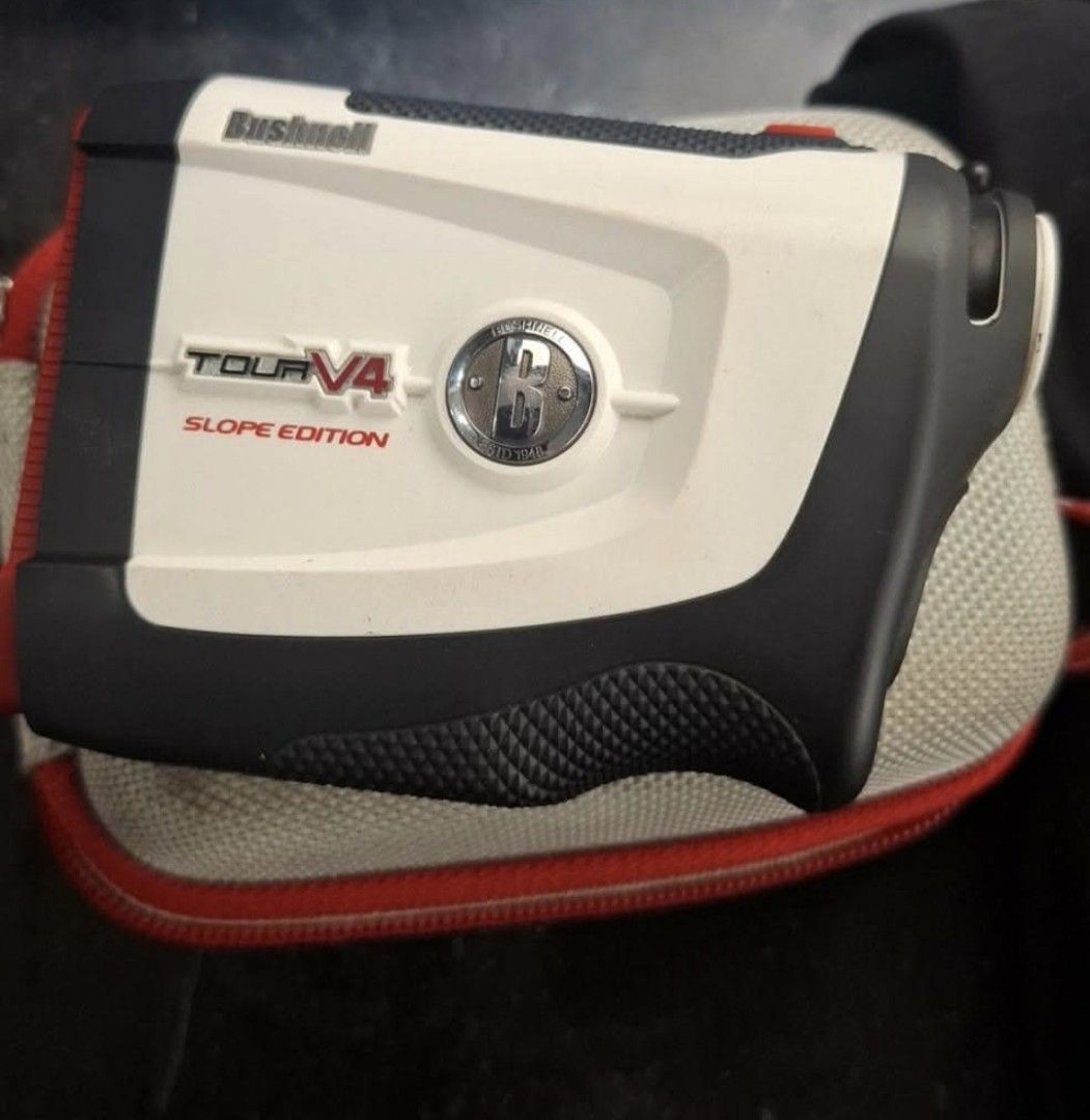 Bushnell Tour V4 Slope Edition Golf Rangefinder (Category: Golf) located in Manila. Submitted by wongkarwai77 (Listing ID 1465089097, Image 1). Description: - Brand: Bushnell Tour V4 Slope Edition laser rangefinder - Color: White and black - Condition: Clean battery door and eyepiece, well-maintained - Features: Compact build with a textured bottom grip for stable handling - Accuracy: Precision tool for checking distances on the golf course - Inc