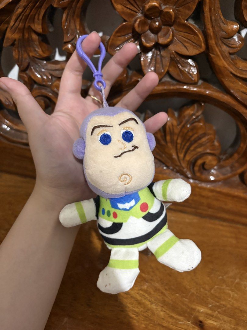 Buzz Lightyear Toy Story 4 Plush Keychain (Category: Plushies & Soft Toys) located in Quezon City. Submitted by rxyel (Listing ID 1465020476, Image 2). Description: - Character: Buzz Lightyear from Toy Story 4 - Material: Soft fabric body with embroidered facial and suit details - Hardware: Purple plastic clasp attached to the head for easy hanging - Authenticity: Comes with official Disney Pixar brand tag.