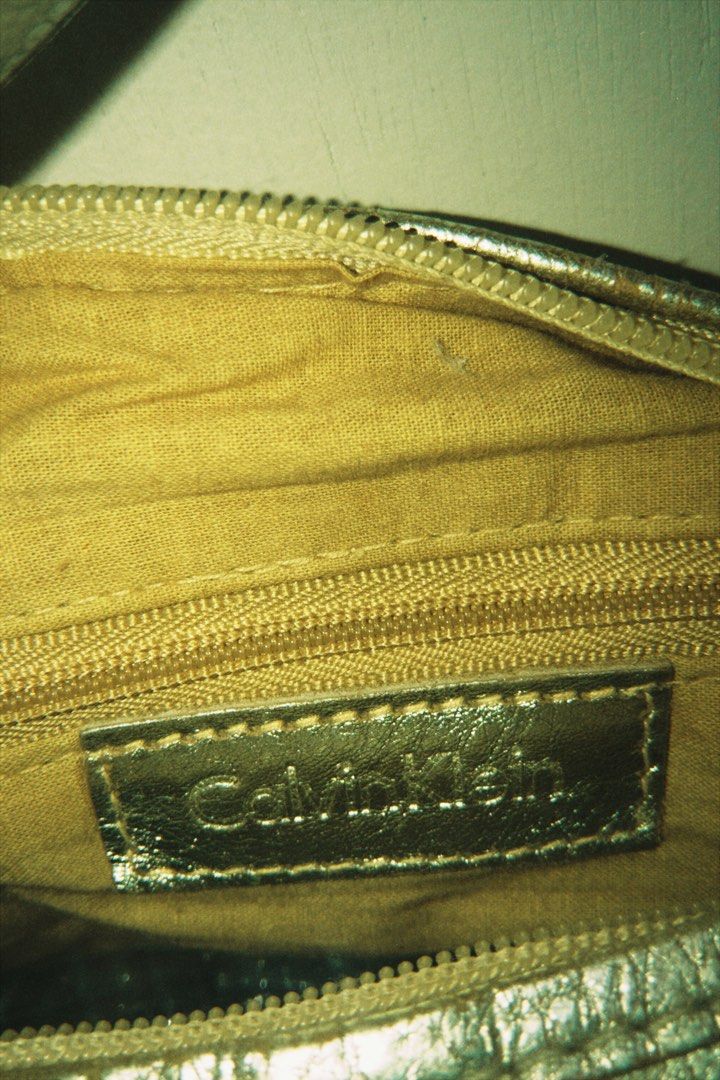 Calvin Klein Gold Bag (Category: Luxury Bags & Wallets) located in Batangas. Submitted by cllavz (Listing ID 1464994038, Image 2). Description: Authentic Calvin Klein Metallic Shoulder Bag – Also shows signs of storage wear on some parts..