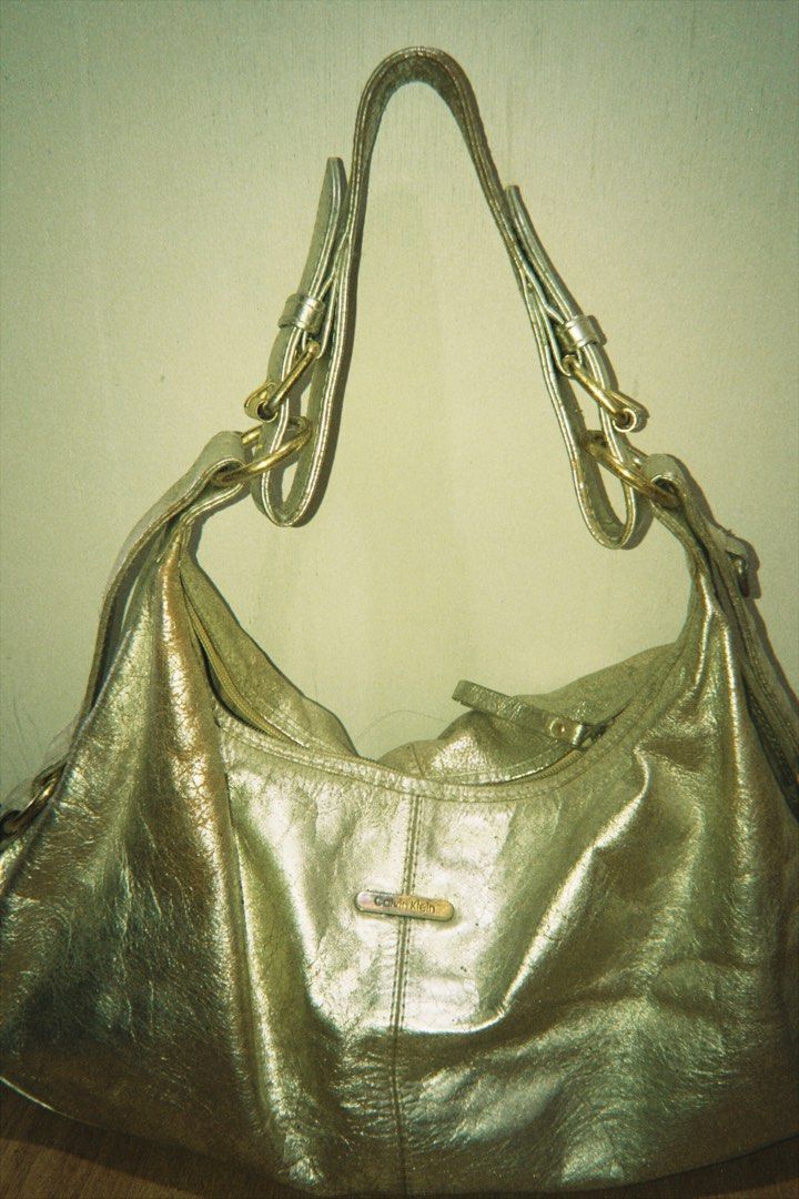 Calvin Klein Gold Bag (Category: Luxury Bags & Wallets) located in Batangas. Submitted by cllavz (Listing ID 1464994038, Image 1). Description: Authentic Calvin Klein Metallic Shoulder Bag – Also shows signs of storage wear on some parts..