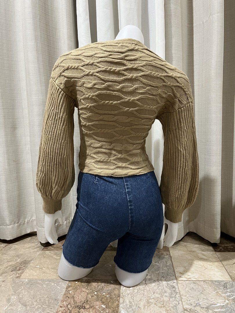 Camel Cable Knit Wrap Crop Sweater (Category: Coats, Jackets and Outerwear) located in Tarlac. Submitted by thriftygoodss (Listing ID 1465099642, Image 3). Description: - Color: Camel - Size: XS - Material: 100% acrylic - Design: Wrap front with V-neckline - Sleeves: Long balloon sleeves with ribbed cuffs - Fit: Cropped length - Condition: Excellent.
