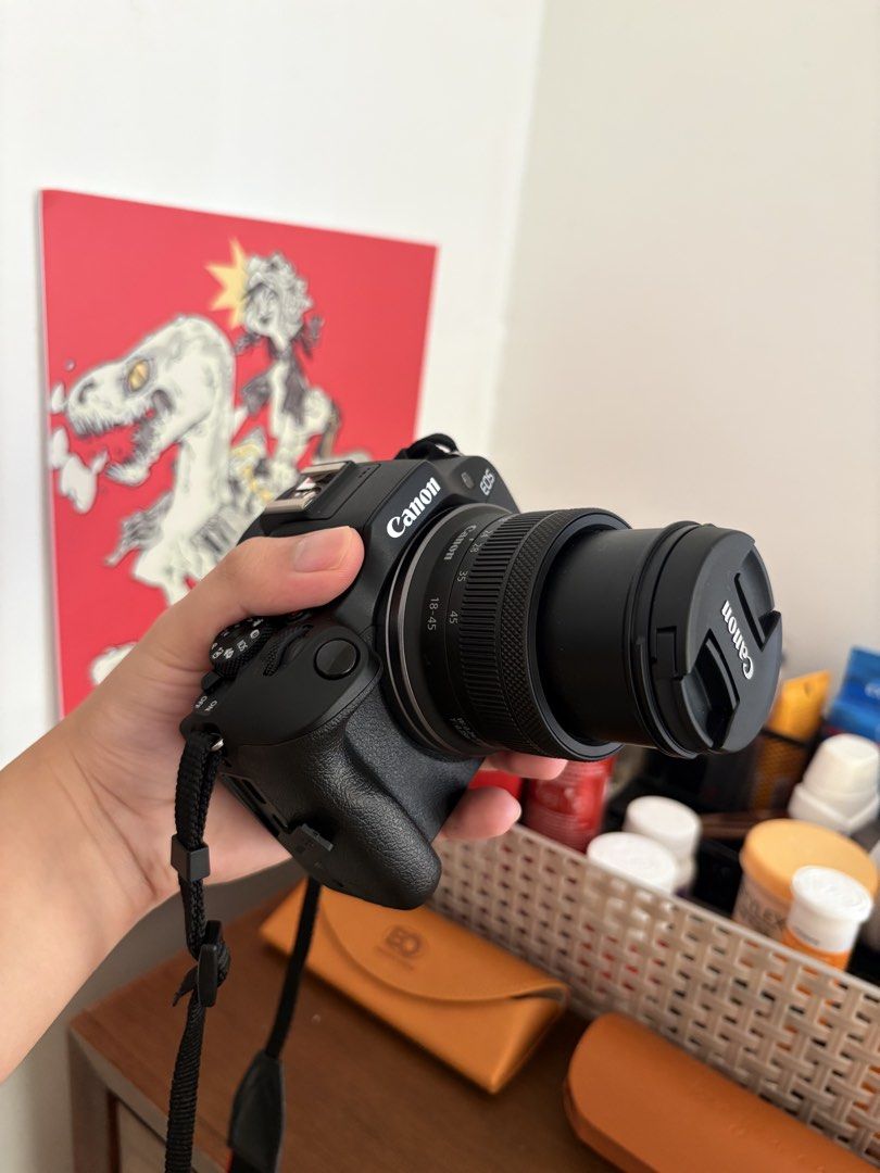 Canon EOS R100 Mirrorless Camera RF-S 18-45mm Kit (Category: Cameras) located in Tanza. Submitted by crsll_ninja (Listing ID 1464978351, Image 1). Description: Canon EOS R100 camera kit with RF-S 18-45mm lens. Bought this April 2026 for 40k at Photoline. Condition is 9.9/10 mint Seldomly used and strictly dry cabinet stored with no issues or scratches. RFS: Need emergency funds Includes camera unit (+ kit lens), original box, charger, battery, an