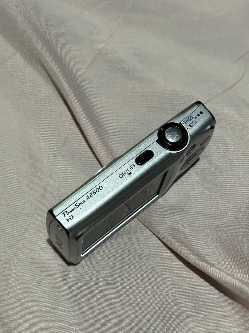 Canon PowerShot A2500 Digital Camera 16.0 Megapixels (Category: Cameras) located in Manila. Submitted by prlvdbypau (Listing ID 1465046971, Image 3). Description: - Camera: Canon PowerShot A2500 in Silver - Condition: Powers up and shoots great, with minor scuffs from normal use - Specs: 16.0 megapixels with 5x optical zoom - Vibe: Perfect for authentic Y2K aesthetic photos - Inclusions: Battery pack NB-11L, 2GB SD memory card, and a black carryi