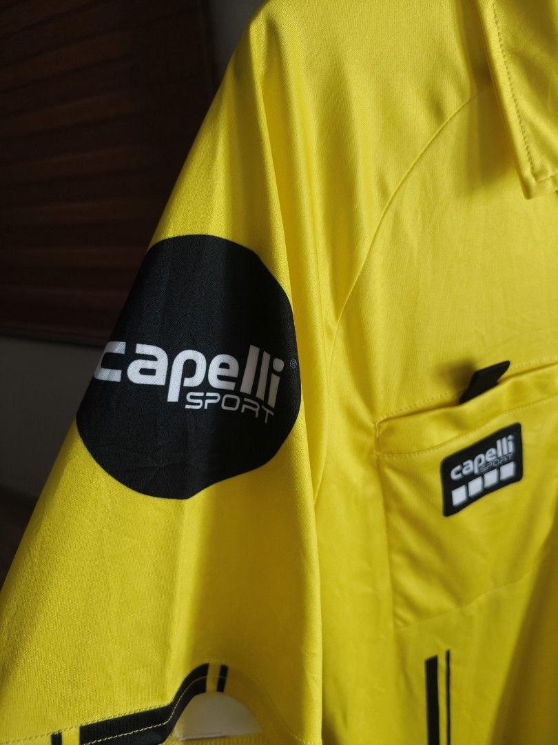 Capelli Sport Us Soccer Referee Jersey 2024 (Category: Tshirts & Polo Shirts ) located in Siniloan. Submitted by wingedwardrobe (Listing ID 1453558694, Image 2). Description: A bright yellow Capelli Sport U.S. Soccer Federation 2024 referee jersey with polo collar, two front chest pockets with Capelli and USA referee badges, black stripe details down the front, and Capelli Sport logo on the sleeve. 📢 𝐒𝐇𝐎𝐏 𝐑𝐄𝐌𝐈𝐍𝐃𝐄𝐑𝐒 📢 - 𝐒𝐢𝐳𝐞𝐬 �