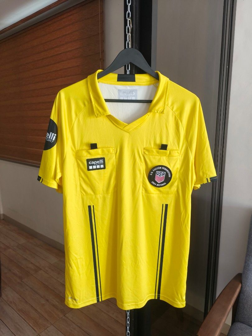 Capelli Sport Us Soccer Referee Jersey 2024 (Category: Tshirts & Polo Shirts ) located in Siniloan. Submitted by wingedwardrobe (Listing ID 1453558694, Image 1). Description: A bright yellow Capelli Sport U.S. Soccer Federation 2024 referee jersey with polo collar, two front chest pockets with Capelli and USA referee badges, black stripe details down the front, and Capelli Sport logo on the sleeve. 📢 𝐒𝐇𝐎𝐏 𝐑𝐄𝐌𝐈𝐍𝐃𝐄𝐑𝐒 📢 - 𝐒𝐢𝐳𝐞𝐬 �
