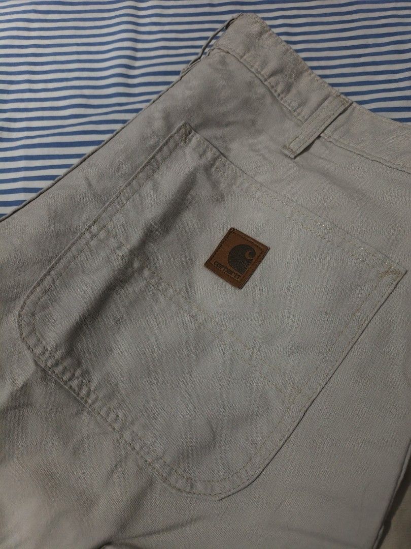 Carhartt B144 PUT Canvas Work Utility Shorts Size 33 (Category: Shorts) located in Caloocan City. Submitted by bry_anjay (Listing ID 1465030679, Image 2). Description: - Brand: Carhartt - Style: B144 PUT Canvas Utility Shorts - Color: Light Beige - Size: Tagged 33 waist - Material: Rugged cotton duck fabric - Features: Classic carpenter pocket setup, leather logo patch on back pocket, branded metal button, heavy-duty belt loops - Condition: Clean