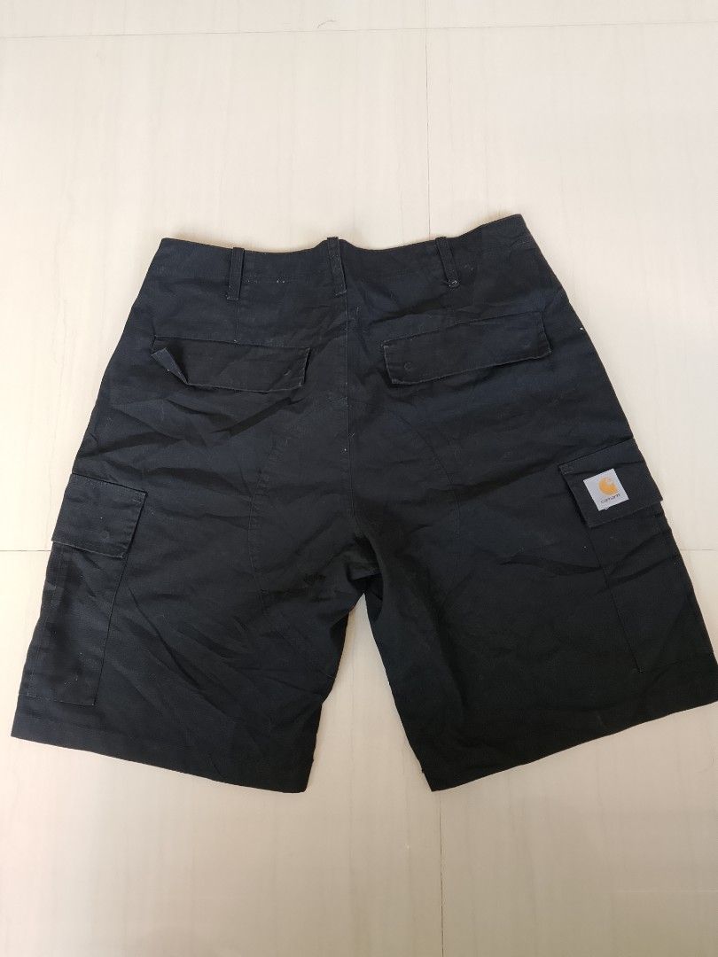 Carhartt WIP Regular Cargo Short Black Size L (Category: Shorts) located in Manila. Submitted by arjaygoodfind (Listing ID 1465011750, Image 2). Description: - Brand: Carhartt WIP - Style: Regular Cargo Shorts - Color: Black - Size: Large (L) - Material: 100% Cotton (Outer & Pocket Lining) - Features: Multiple side and back utility pockets with snap flap closures, button fly waist, and belt loops - Detail: Signature woven Carhartt square label on