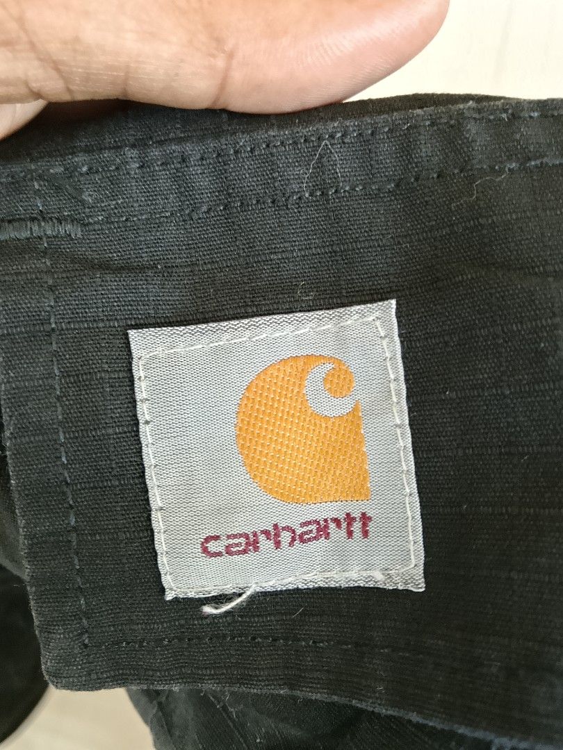 Carhartt WIP Regular Cargo Short Black Size L (Category: Shorts) located in Manila. Submitted by arjaygoodfind (Listing ID 1465011750, Image 3). Description: - Brand: Carhartt WIP - Style: Regular Cargo Shorts - Color: Black - Size: Large (L) - Material: 100% Cotton (Outer & Pocket Lining) - Features: Multiple side and back utility pockets with snap flap closures, button fly waist, and belt loops - Detail: Signature woven Carhartt square label on