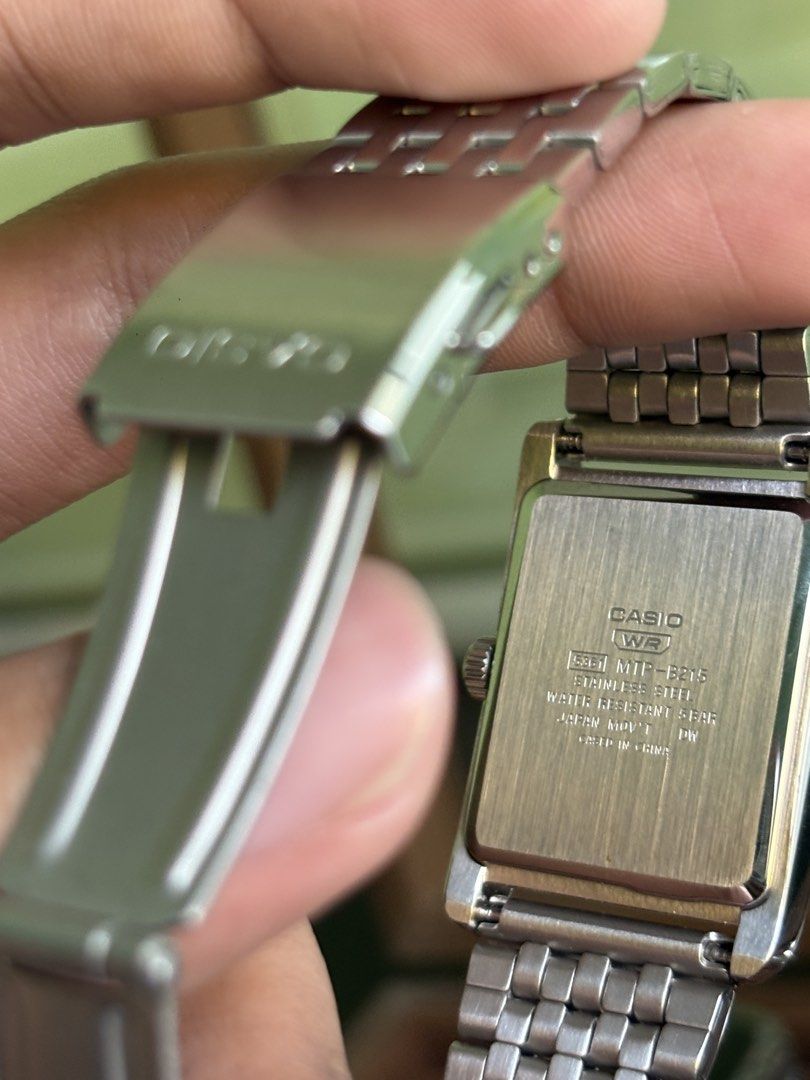 Casio Rectangular Watch - Ref# MTPB251D (Category: Men's Watches) located in Quezon City. Submitted by renceeeyy06 (Listing ID 1463069989, Image 2). Description: - Classic Casio watch - Rectangular face - Silver metal strap - Dark grey dial with gold-tone hands and markers - Simple and sleek design - Water resistant 50m - Includes original box - Complete links - 1 year warranty 'til September 2027 ✅ Money-back guarantee if proven fake 📍 Mandaluy