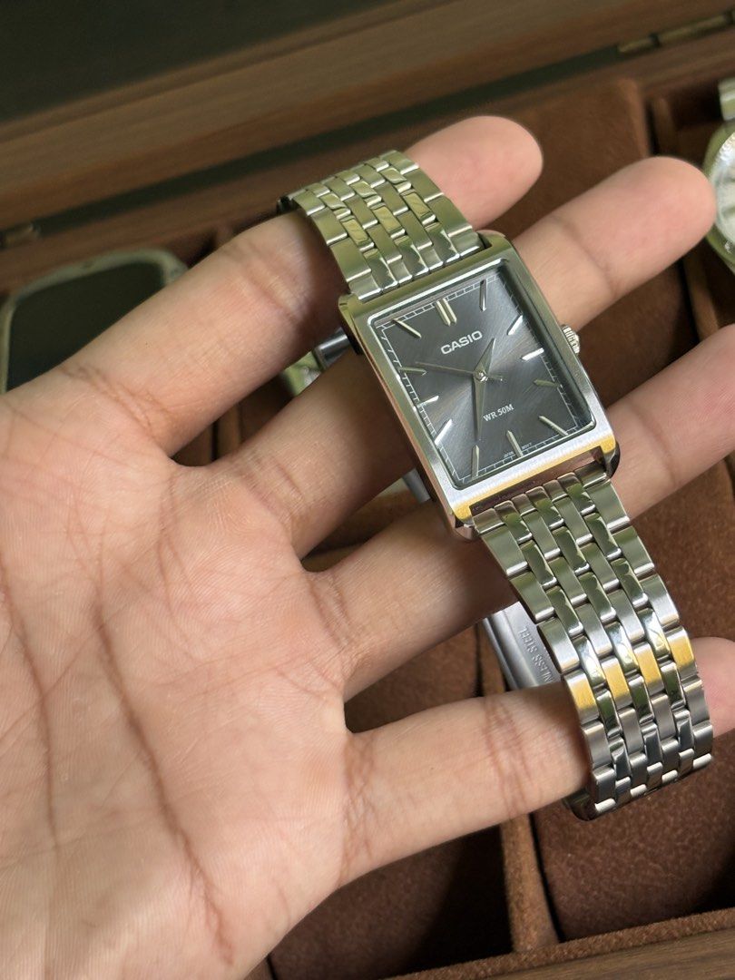 Casio Rectangular Watch - Ref# MTPB251D (Category: Men's Watches) located in Quezon City. Submitted by renceeeyy06 (Listing ID 1463069989, Image 3). Description: - Classic Casio watch - Rectangular face - Silver metal strap - Dark grey dial with gold-tone hands and markers - Simple and sleek design - Water resistant 50m - Includes original box - Complete links - 1 year warranty 'til September 2027 ✅ Money-back guarantee if proven fake 📍 Mandaluy