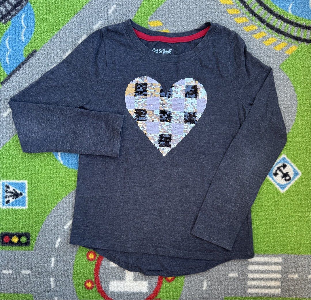 Cat & Jack Long Sleeve Heart Sequin Shirt (Category: Babies & Kids Fashion) located in Rizal. Submitted by preloovved (Listing ID 1465096084, Image 2). Description: Cat & Jack dark grey long sleeve top for kids featuring a fun reversible sequin heart (pink/black plaid to silver/black plaid). Made from a soft cotton blend with a cute curved back hem and red inner collar trim. Perfect for everyday wear. Cat & Jack long-sleeved shirt with a heart-sh