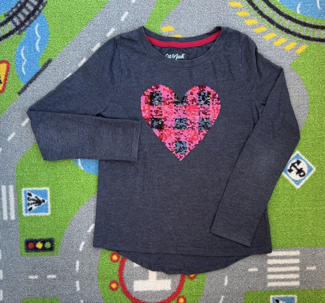 Cat & Jack Long Sleeve Heart Sequin Shirt (Category: Babies & Kids Fashion) located in Rizal. Submitted by preloovved (Listing ID 1465096084, Image 1). Description: Cat & Jack dark grey long sleeve top for kids featuring a fun reversible sequin heart (pink/black plaid to silver/black plaid). Made from a soft cotton blend with a cute curved back hem and red inner collar trim. Perfect for everyday wear. Cat & Jack long-sleeved shirt with a heart-sh