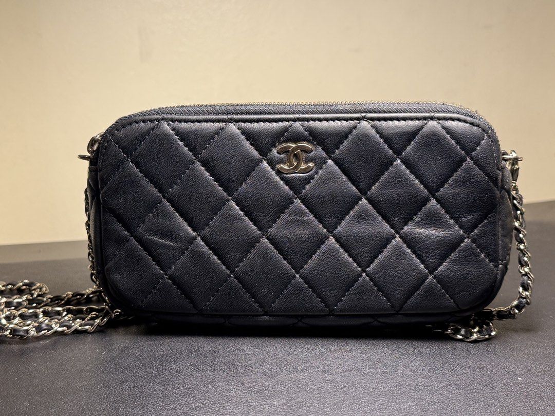 Chanel Quilted Leather Camera Case Crossbody Bag (Category: Cross-body Bags) located in Manila. Submitted by zuji.ph (Listing ID 1464997588, Image 1). Description: - Chanel wallet in classic black quilted leather - Silver-tone hardware with iconic interlocking CC logo on the front - Elegant interwoven chain-leather strap - Clean burgundy fabric lining with Chanel heat stamp - Made in Italy with serial number sticker: 22814538 - Secure zip top clo