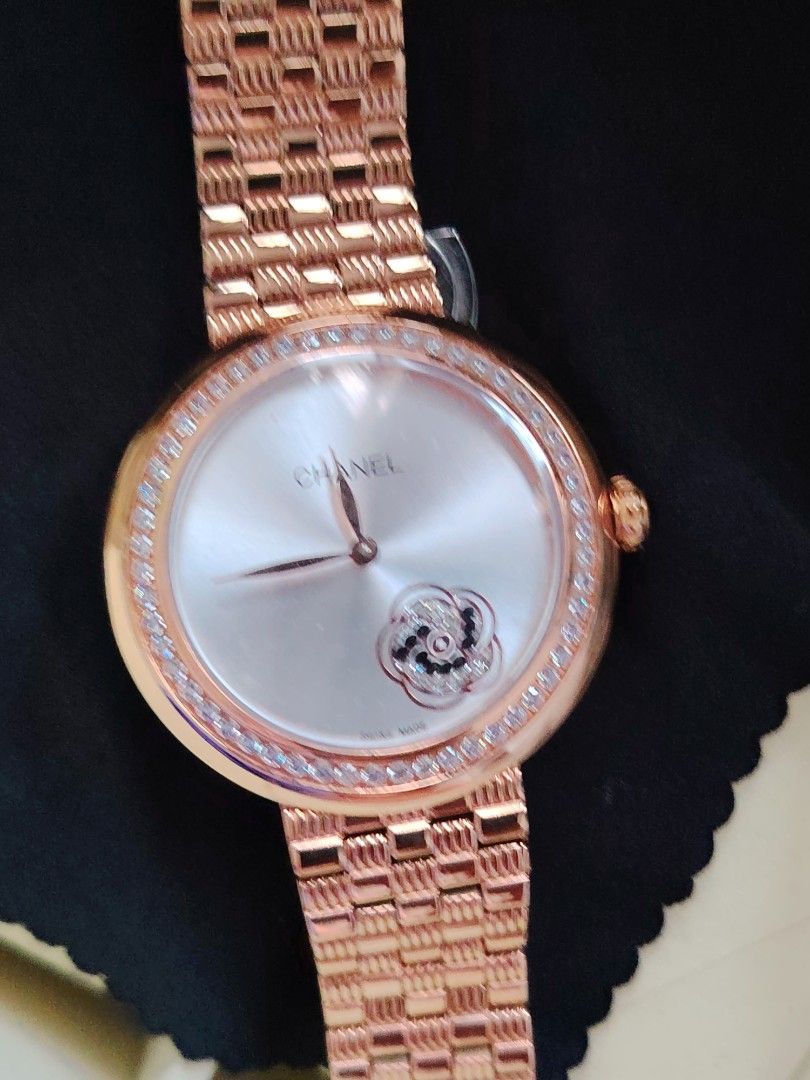 Chanel Rose Gold Diamond Bezel Watch (Category: Women's Watches) located in Paranaque City. Submitted by lucille1280 (Listing ID 1464994810, Image 1). Description: - Authentic Chanel rose gold watch - Round silver sunburst dial with crystal-accented floral motif - Bezel entirely set with sparkling small -replica crystals - Matching rose gold link bracelet with secure deployment clasp - Crown features a chic dark cabochon stone inset - Case back e