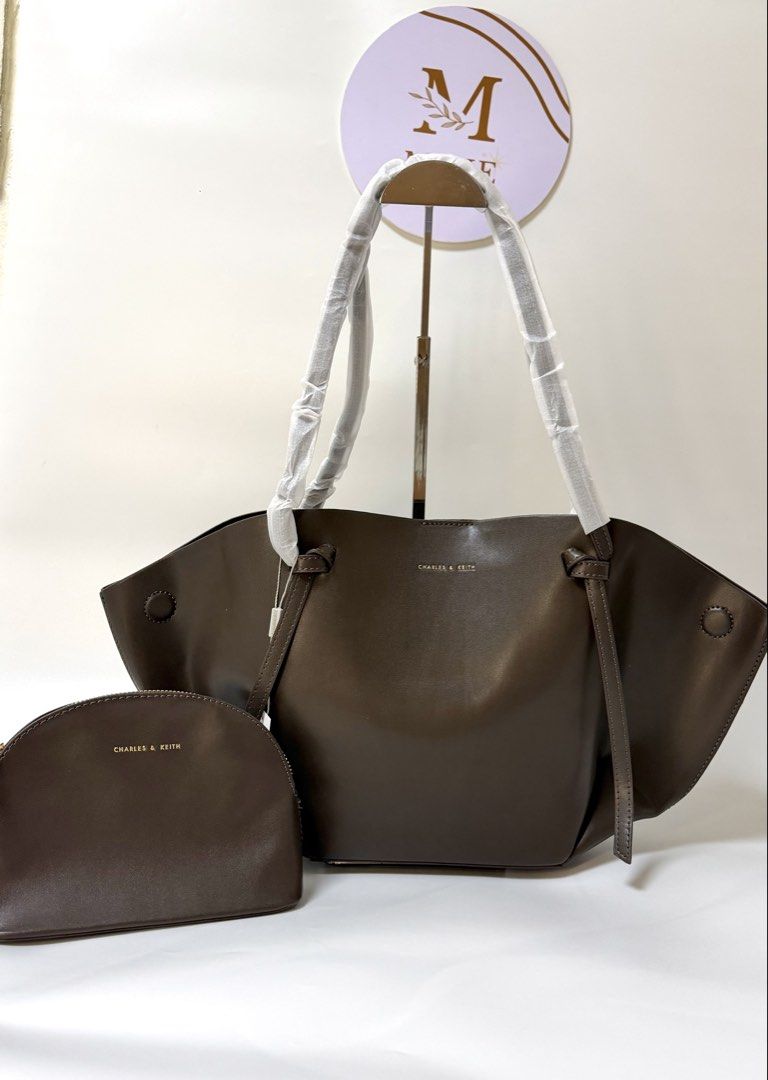 Charles & Keith Dark Brown Tote Bag with Pouch (Category: Tote Bags) located in Manila. Submitted by happydragon_56bba5 (Listing ID 1465083779, Image 1). Description: - Brand: Charles & Keith - Color: Dark Brown - Condition: Brand new with tag and handle foam protection - Inclusions: Matching inner zip pouch and original shopping bag - Style: Classic and spacious tote bag, ideal for daily use or work.