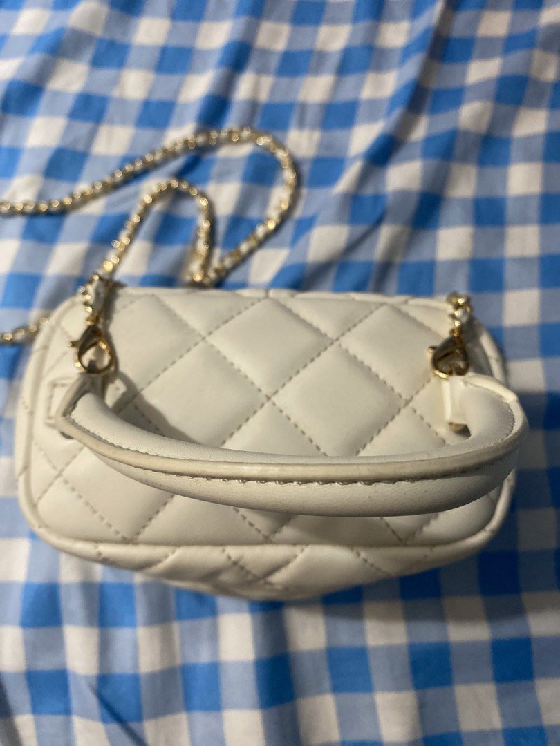 Charles & Keith White Quilted Vanity Bag (Category: Cross-body Bags) located in Las Pinas. Submitted by j_malic (Listing ID 1465098938, Image 2). Description: - Brand: Charles & Keith - Color/Style: White quilted vanity bag with structured boxy shape - Hardware: Elegant gold-tone zippers - Straps: Includes both a top handle and a chain strap - Interior: Clean lining complete with original brand tag and product label.