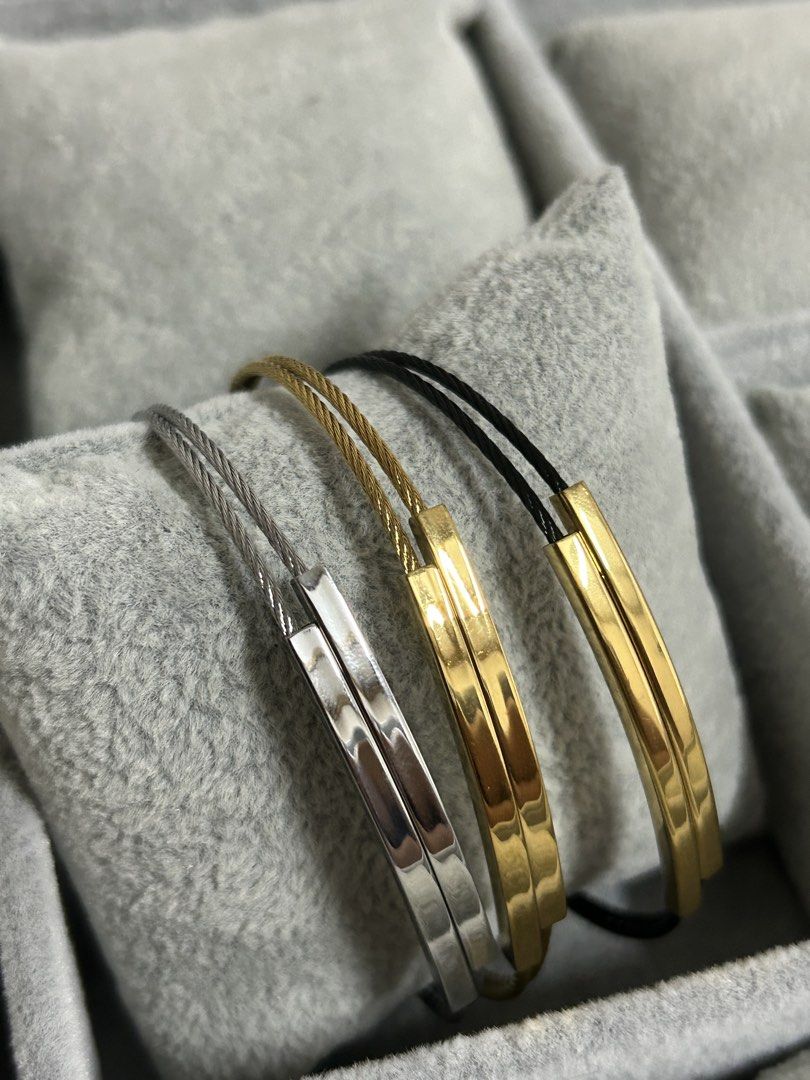 Charriol Cable Wire Stainless Steel Bracelet (Category: Jewelry) located in Manila. Submitted by elonlineshop (Listing ID 1465169165, Image 1). Description: Charriol wire cable bracelets. Includes one silver with silver clasp, one gold with gold clasp, and one black cable with gold clasp. Distinct engraved Charriol branding on the metal clasp bars. Secure clip lock closure mechanism. Stack them together or wear separately. Minimalist everyday jew