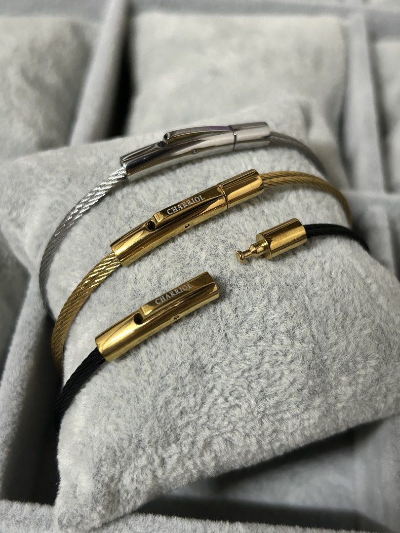 Charriol Cable Wire Stainless Steel Bracelet (Category: Jewelry) located in Manila. Submitted by elonlineshop (Listing ID 1465169165, Image 2). Description: Charriol wire cable bracelets. Includes one silver with silver clasp, one gold with gold clasp, and one black cable with gold clasp. Distinct engraved Charriol branding on the metal clasp bars. Secure clip lock closure mechanism. Stack them together or wear separately. Minimalist everyday jew