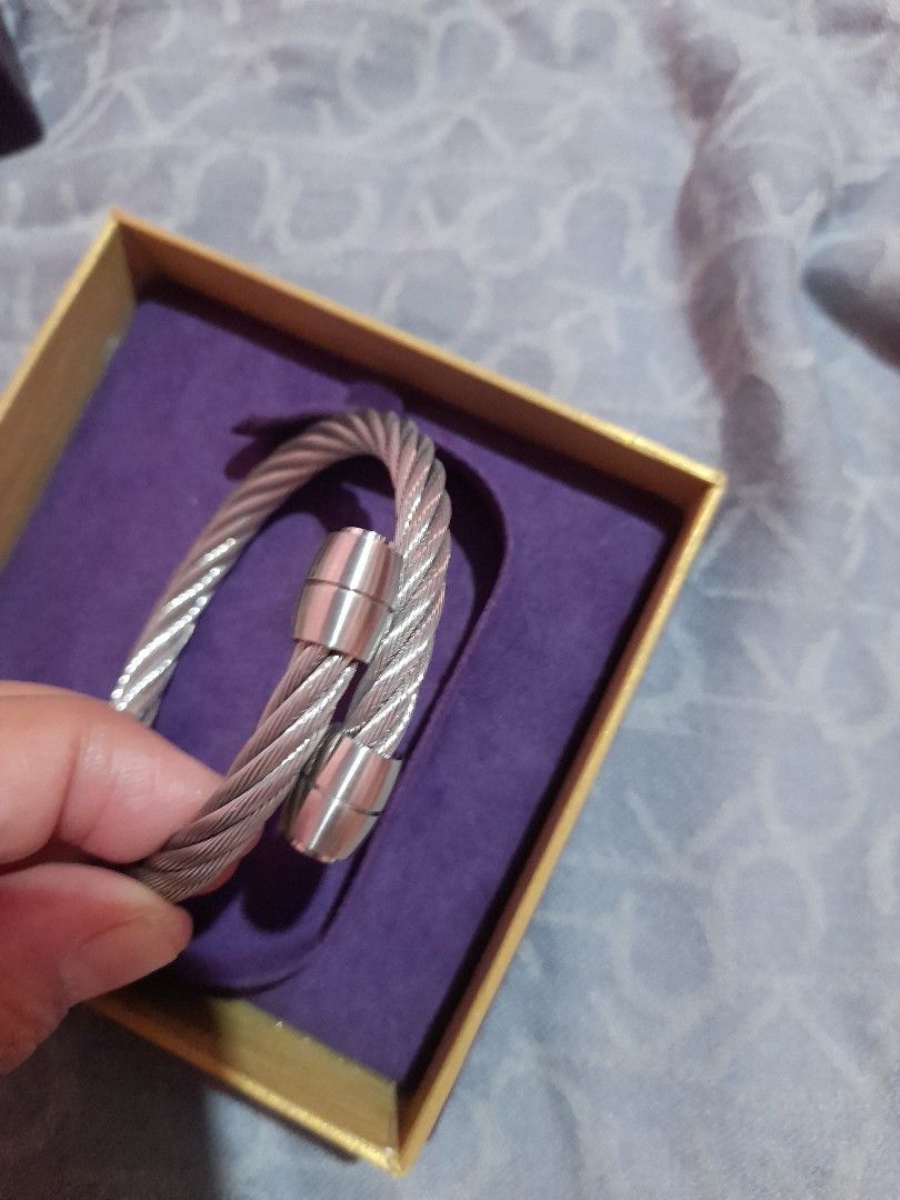 Charriol Geneve Twisted Cable Bangle Bracelet medium size (Category: Bracelets) located in Manila. Submitted by goodbuying_items0211 (Listing ID 1465170376, Image 3). Description: - Authentic Charriol Geneve steel cable bangle bracelet - Open cuff design with secure capped ends - Classic silver-tone twist wire style - Pristine, well-kept condition stored in its case - Includes original purple presentation box, outer packaging, and warranty card.