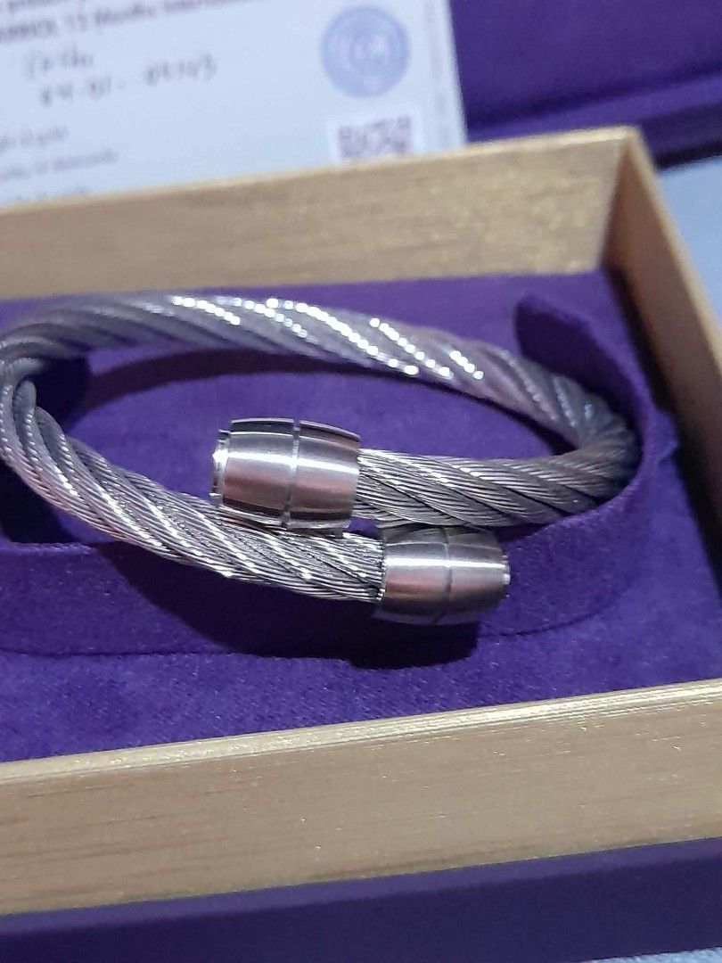 Charriol Geneve Twisted Cable Bangle Bracelet medium size (Category: Bracelets) located in Manila. Submitted by goodbuying_items0211 (Listing ID 1465170376, Image 2). Description: - Authentic Charriol Geneve steel cable bangle bracelet - Open cuff design with secure capped ends - Classic silver-tone twist wire style - Pristine, well-kept condition stored in its case - Includes original purple presentation box, outer packaging, and warranty card.