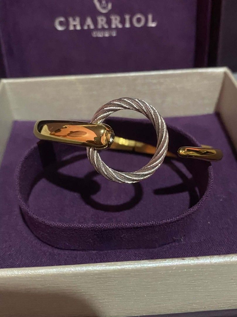 Charriol Infinity Zen Bracelet (Category: Bracelets) located in Manila. Submitted by goodbuying_items0211 (Listing ID 1465170555, Image 2). Description: Charriol Infinity Zen bangle bracelet in gold and silver tone steel cable design. Features a circular charm element with a stone detail. Reference number 04-104-1232-05. Original box, paper bag, and international warranty card dated May 31, 2026 included. 💯 Original.