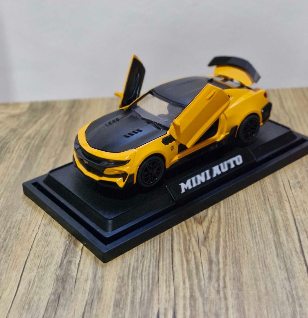 Chevrolet Camaro Die-Cast Model Car (Category: Vehicle & Diecast Models) located in Davao. Submitted by j_guitarist (Listing ID 1465055255, Image 1). Description: - Size: 16 x 6.5 x 4.6 cm - Color: Yellow - Scale: 1:36 - Material: Alloy + Plastic + Rubber - Styled like Bumblebee from Transformers with gull-wing doors and a rear spoiler - Includes a black display base with the brand name plate - Doors and trunk open smoothly. Sounds and lights eff