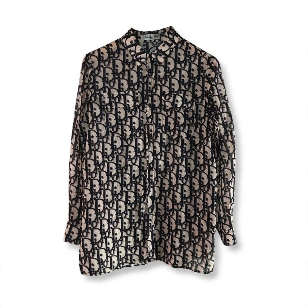CHRISTIAN DIOR | Long Sleeve Button-Down All-Over Monogram Print (Category: Tshirts & Polo Shirts ) located in Naga. Submitted by bossyingthrifts (Listing ID 1464820327, Image 1). Description: CHRISTIAN DIOR | Long Sleeve Button-Down All-Over Monogram Print - Christian Dior button-down Long Sleeve - Iconic all-over oblique monogram print - Chic sheer fabric in beige and dark navy blue - Classic collar with front button closure - Features two prac