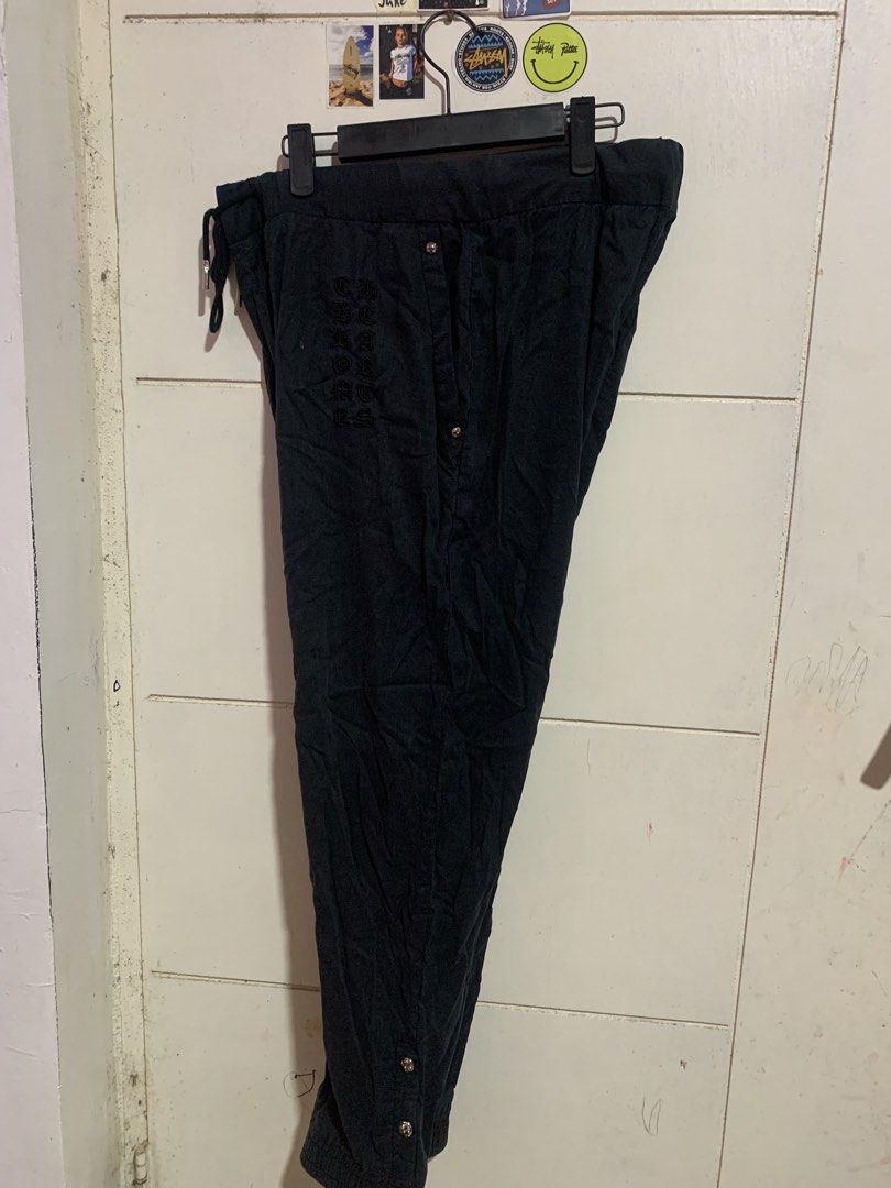Chrome Hearts Black Sweatpants with Silver Hardware (Category: Joggers) located in Bauang. Submitted by jkjk32 (Listing ID 1465111293, Image 2). Description: - Brand: Chrome Hearts - Color: Black with soft dark cotton fabric - Fit: Relaxed, comfortable streetwear style - Details: Vertical logo lettering on one leg and cross patch on the back pocket - Hardware: Genuine sterling silver cross ball buttons on side hems - Waistband: Adjustable drawstr