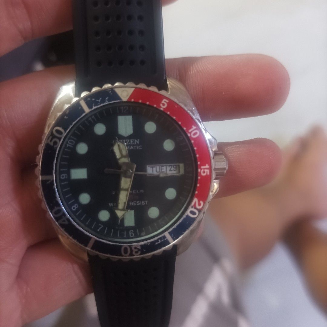 Citizen Automatic Pepsi ny2300 (Category: Men's Watches) located in Caloocan City. Submitted by guraygenes (Listing ID 1464984957, Image 1). Description: - Brand: Citizen automatic diver watch - Bezel & Dial: Classic Pepsi bezel with black day-date dial at 3 o'clock - Strap: Fitted with a black vented rubber strap - Extras: Includes an extra two-tone steel and gold bracelet in a separate bag - Movement: Reliable automatic movement powered by wris