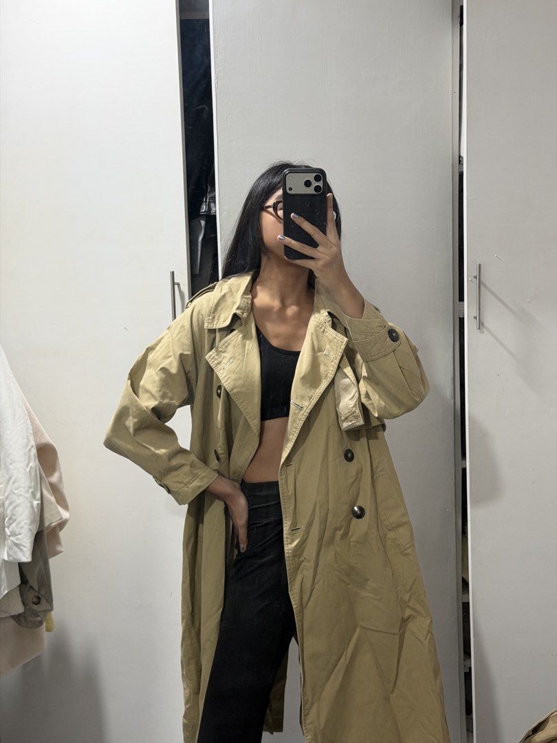 Classic beige double-breasted trench coat long outerwear (Category: Coats, Jackets and Outerwear) located in Pasig City. Submitted by miss_abuelita (Listing ID 1465115205, Image 3). Description: - Classic beige trench coat with a chic, oversized fit - Long length that falls below the knee - Stylish double-breasted tortoiseshell buttons - Detailed with shoulder epaulets and front storm flaps - Structured, premium material - Perfect layering piece 