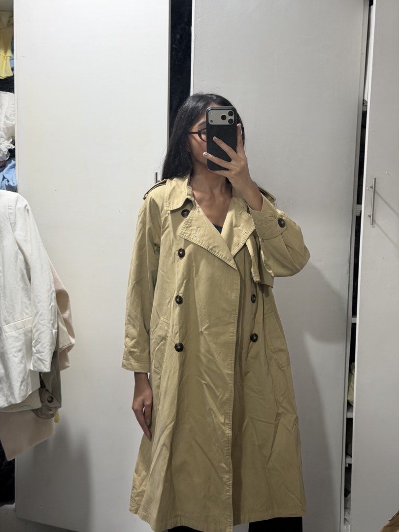 Classic beige double-breasted trench coat long outerwear (Category: Coats, Jackets and Outerwear) located in Pasig City. Submitted by miss_abuelita (Listing ID 1465115205, Image 1). Description: - Classic beige trench coat with a chic, oversized fit - Long length that falls below the knee - Stylish double-breasted tortoiseshell buttons - Detailed with shoulder epaulets and front storm flaps - Structured, premium material - Perfect layering piece 